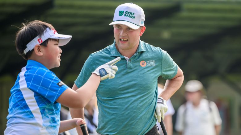 Golfer Kipp Poppert (right) chats with Andreas Ma (left) during the 2024 Hong Kong Open in November.