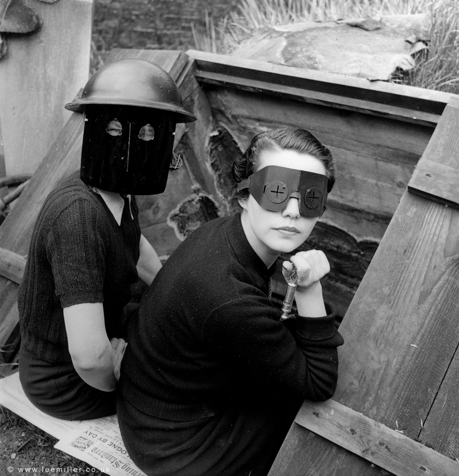 Models pose for Vogue by an air raid shelter in London during the Blitz, wearing masks worn to protect against incendiary bombs.