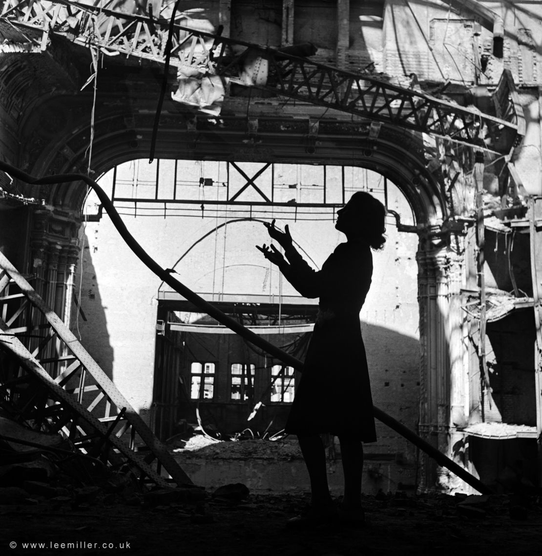 Opera singer Irmgard Seefried singing against the bombed-out Vienna Opera House in November 1945, published in Vogue.