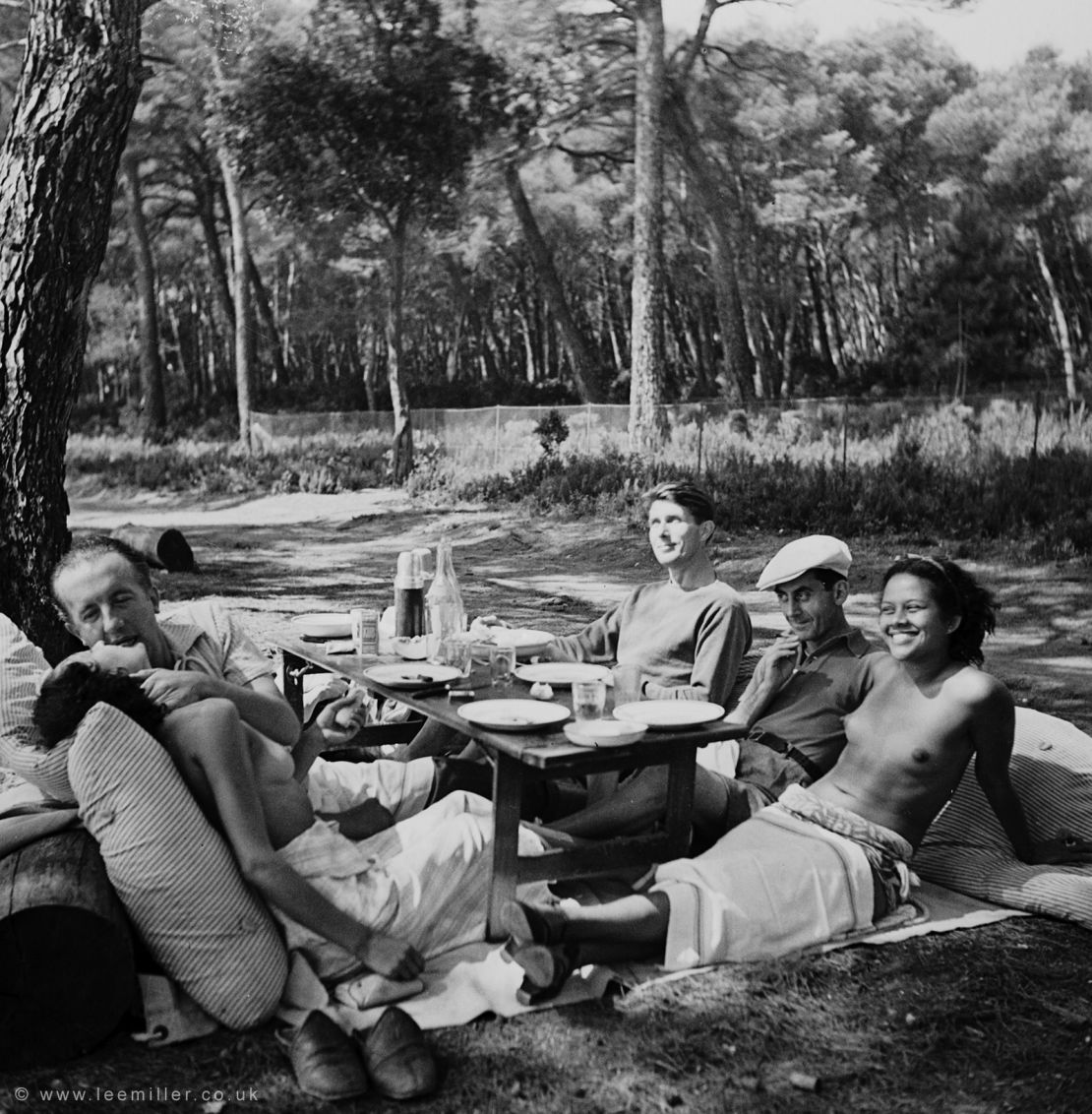 Miller’s close friendships with other artists led to her taking now-famous candid images of the era, including this photograph of the poet and artist Paul and Nusch Éluard (left); Miller's eventual husband, Roland Penrose (back right); and the artist Man Ray and model Ady Fidelin (right).