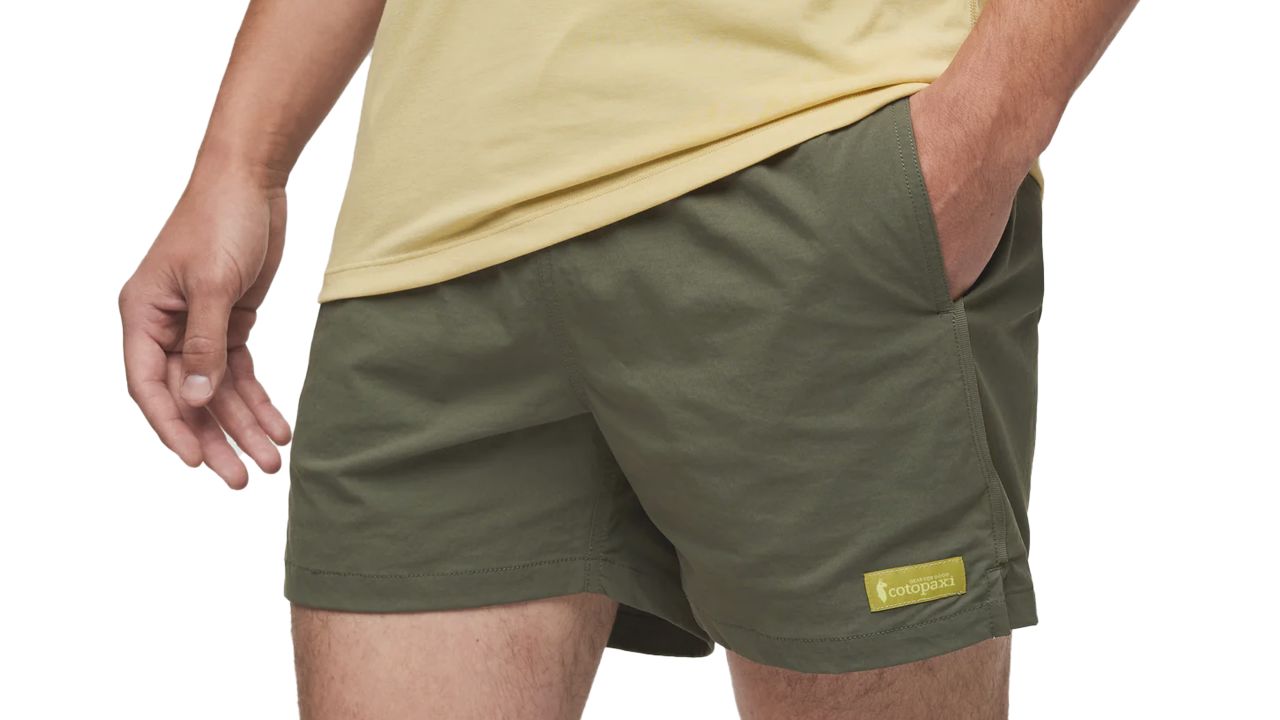 Man wearing cotopaxi brinco shorts in fatigue green