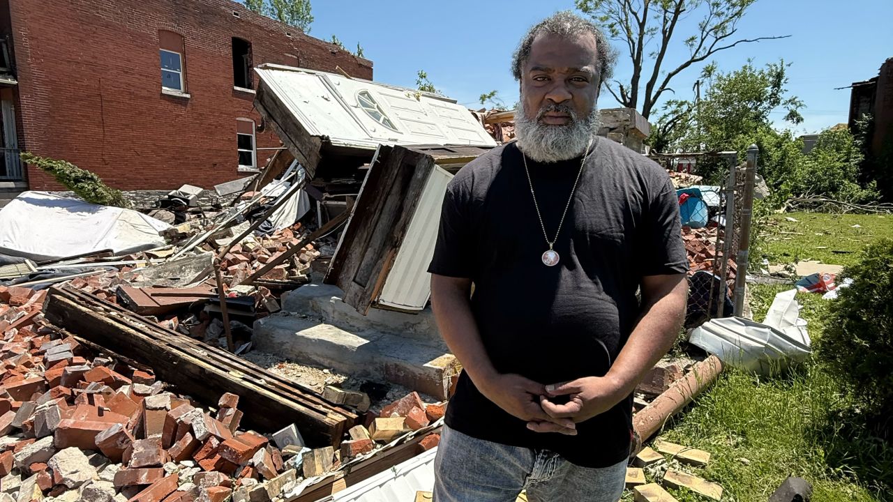 Craig Cole stands next to what’s left of his home after Friday’s tornado in St. Louis.