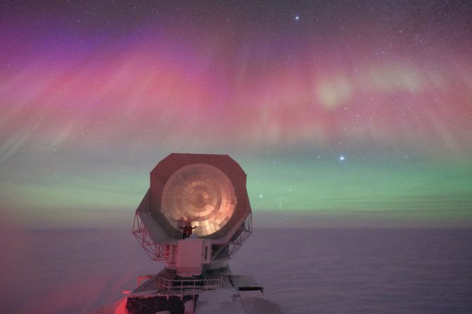 An aurora illuminates the vast South Pole Telescope at the Amundsen-Scott South Pole station.