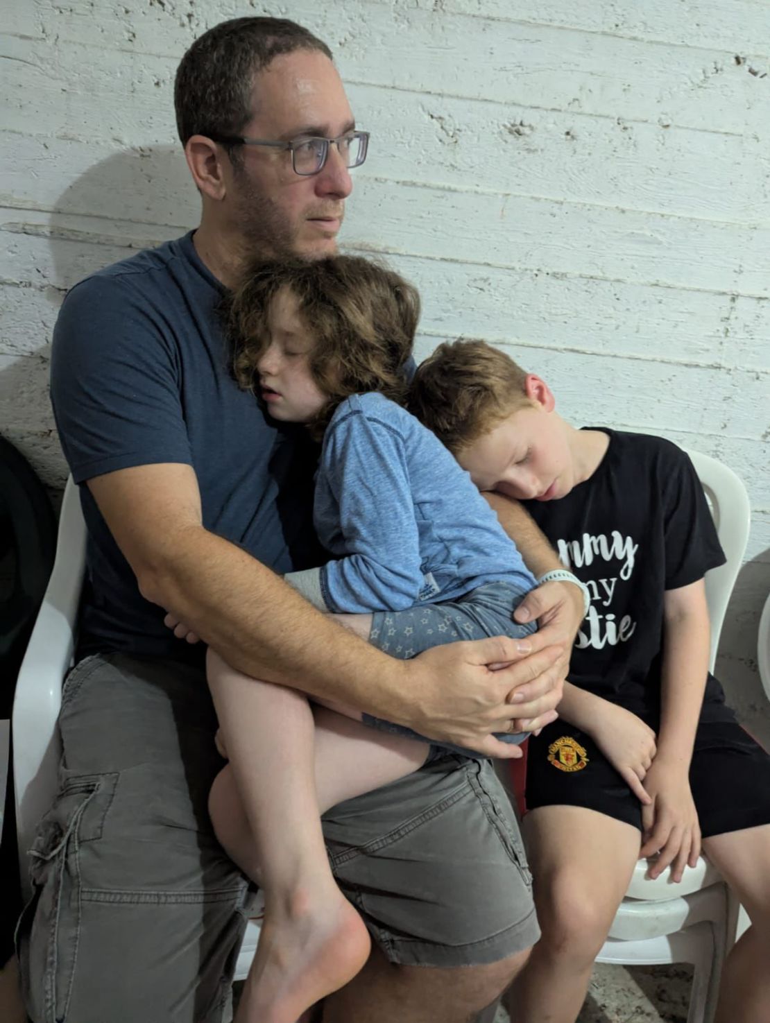 Zohar Shipony embraces her daughter Noa in a bomb shelter, and her son Eitan sleeps in her arms.