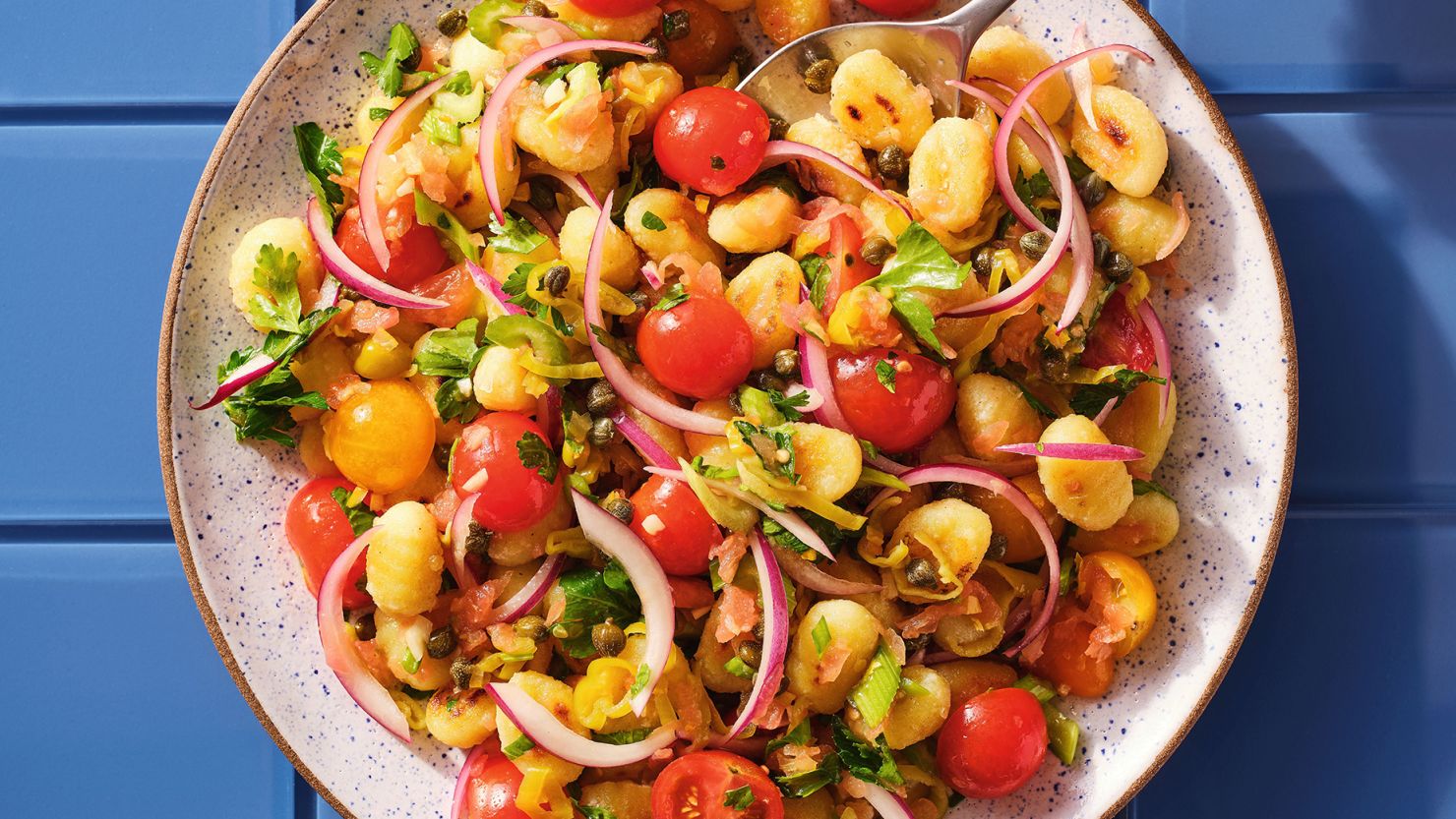 Dan Pashman's recipe for Crispy Gnocchi Salad With Preserved Lemon-Tomato Dressing is inspired by a Moroccan starter salad typically made with tomato and preserved lemon.
