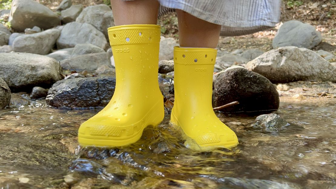 yellow crocs classic boot being tested in a creek