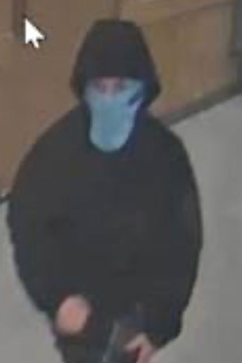 A person in a long face mask and hoodie is seen in a CCTV image released by the Harvard University Police Department on Saturday.