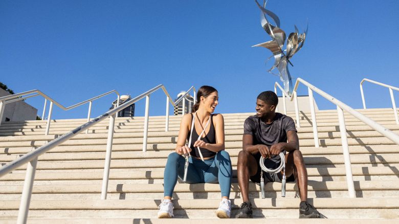 image of two people holding cross rope fitness equipment on stairs