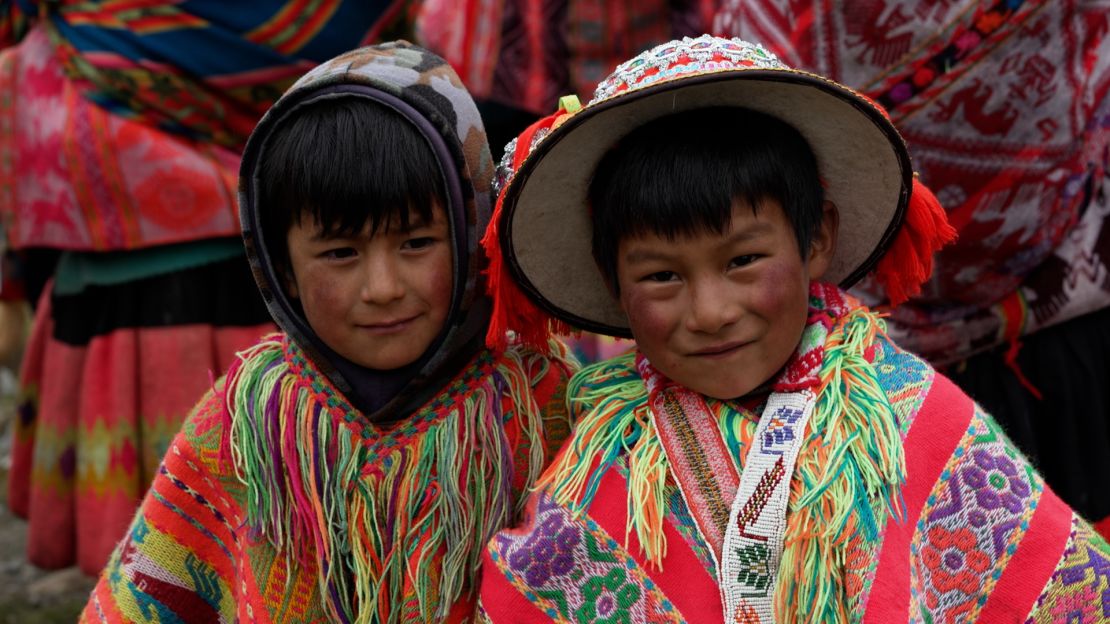 Two boys in traditional dress are photographed during the tree-growing festival, Queuña Raymi.