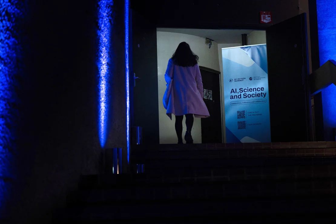 A woman attends the Summit of Action on Artificial Intelligence in Paris on Thursday. Global experts discussed the threats of AI at the meeting, before a world leaders summit about this technology.