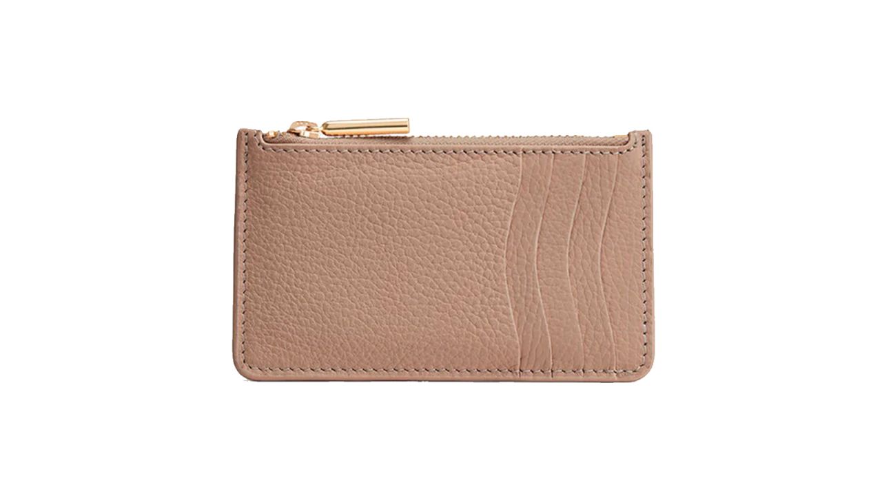 A beige leather wallet against a white background.