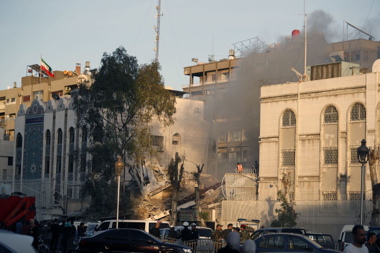 Emergency services work at a building hit by an air strike in Damascus, Syria, on April 1. 