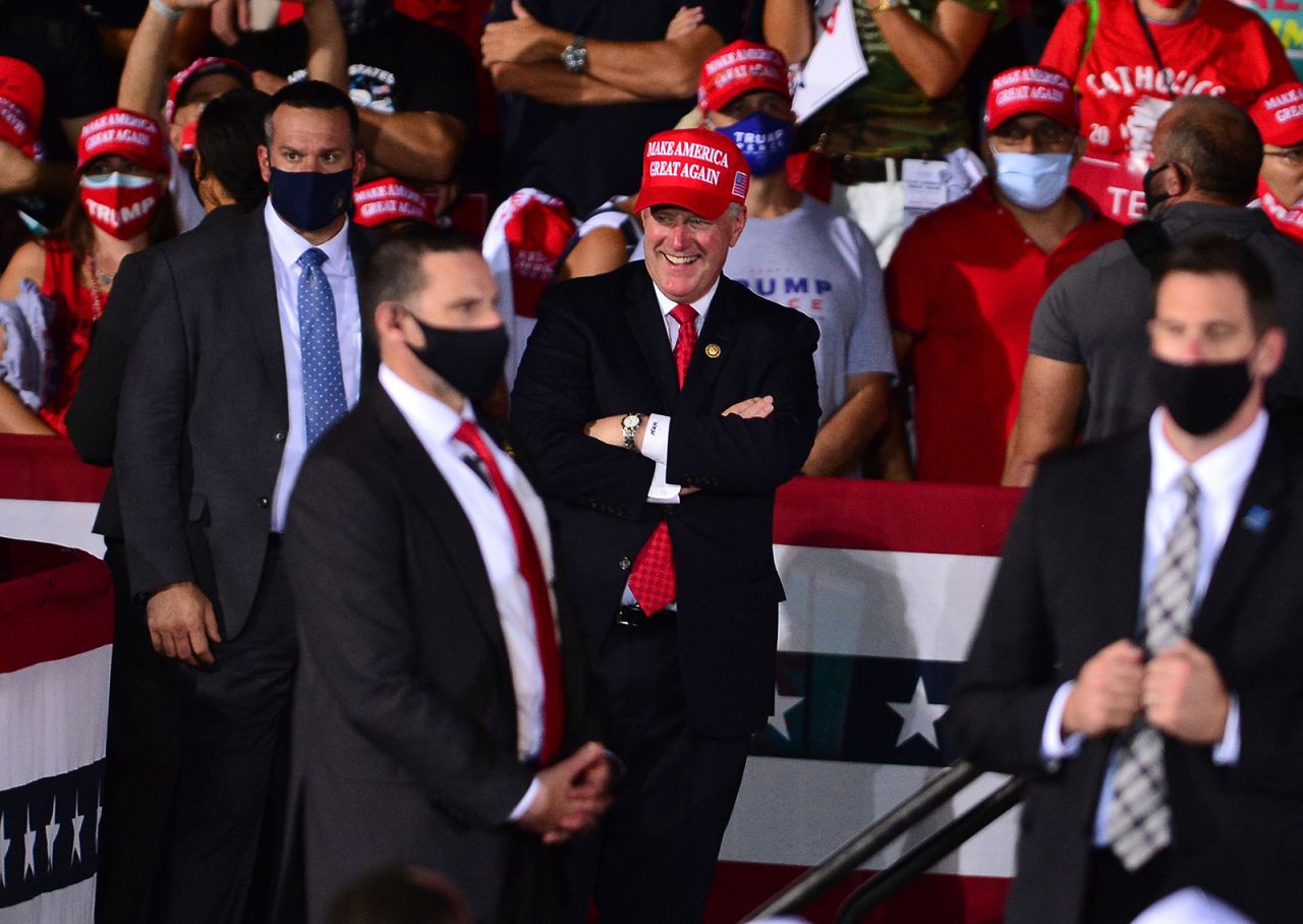 White House Chief of Staff Mark Meadows (center) listens as US President Donald Trump speak during his campaign event at Miami-Opa Locka Executive Airport in Florida, on November 1.