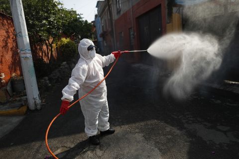 A public safety worker sprays a disinfectant solution in the El Rosario neighborhood of Mexico City, Mexico, on Friday, May 29. 