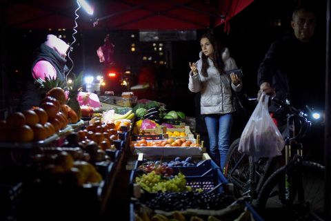 Shoppers look over items at a market in Kyiv, Ukraine on October 27. 