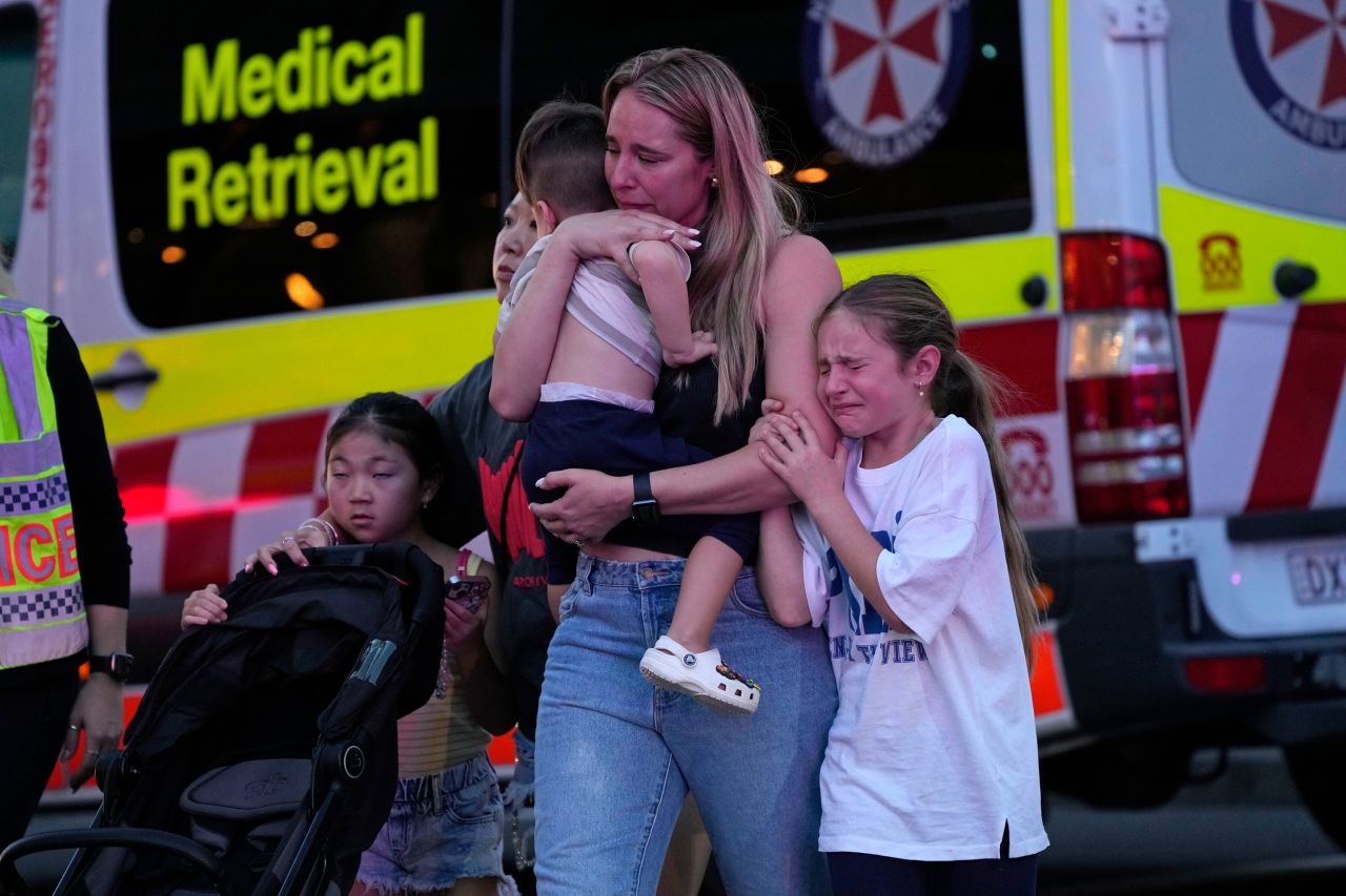 People are led out from the Westfield Bondi Junction shopping center after multiple people were stabbed in Sydney, on April 13. 