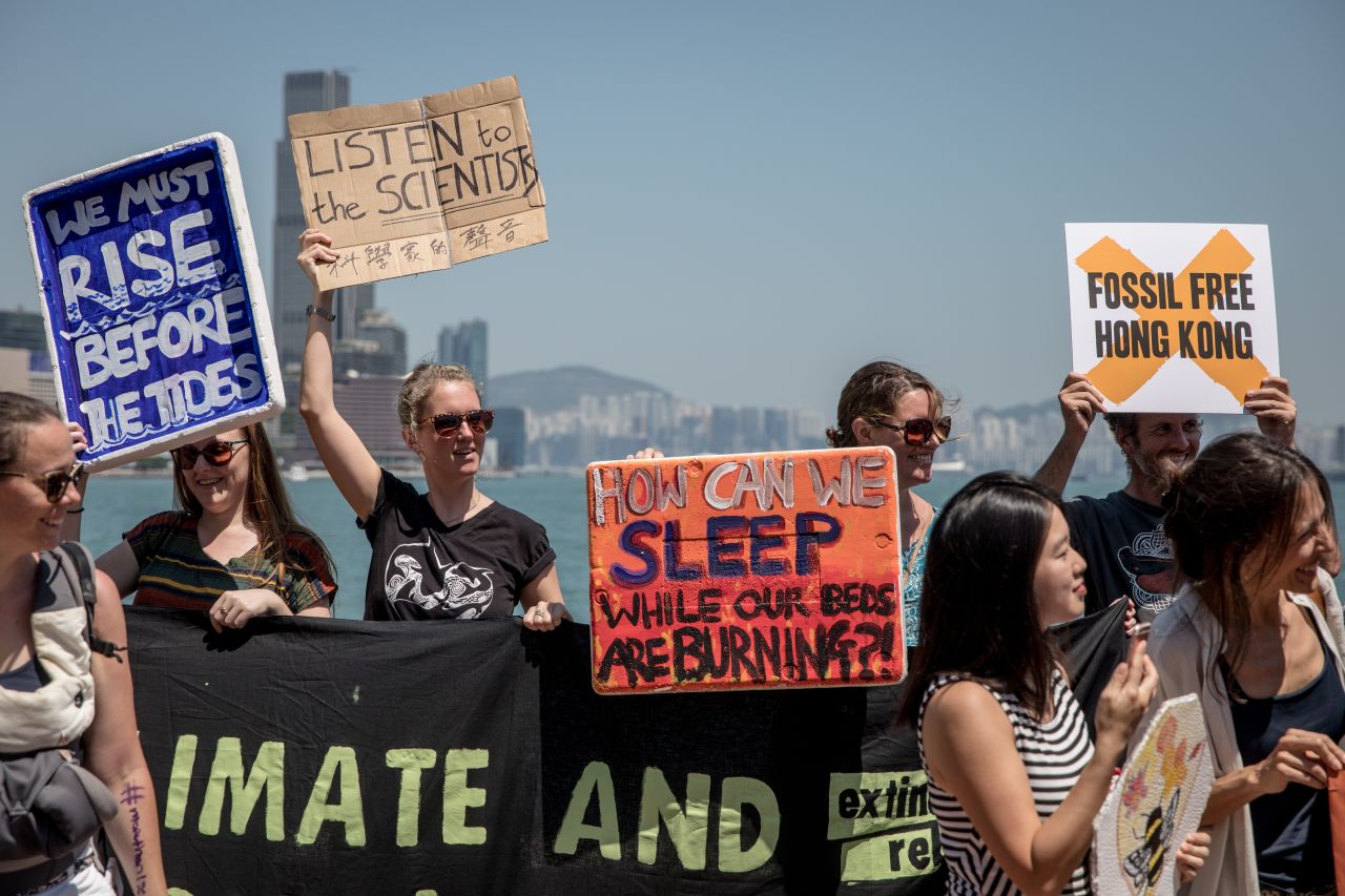 Protesters hold signs and chant slogans during the Hong Kong Climate Strike rally.