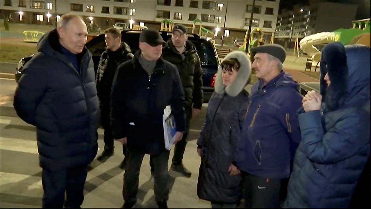 Russian President Vladimir Putin, left, listens to local residents as he visits?Mariupol in Russian-controlled Ukraine, in this still image taken from handout video released on March 19.