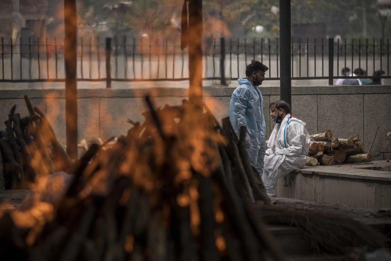 A man performs the last rites for his wife who died of Covid-19 during a mass cremation at a crematorium in New Delhi, India on April 20. 