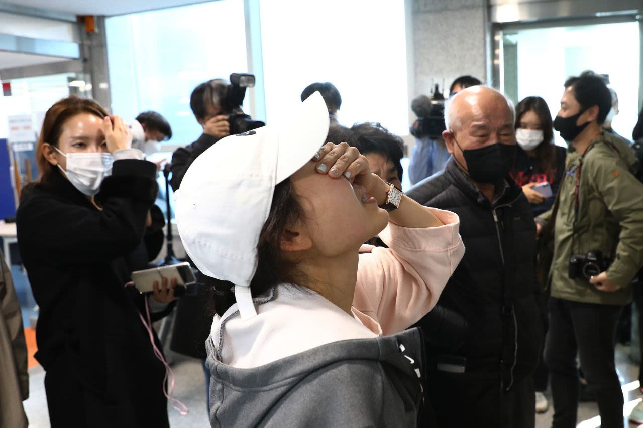 Relatives of missing people weep at a community service center in Seoul on October 30. 