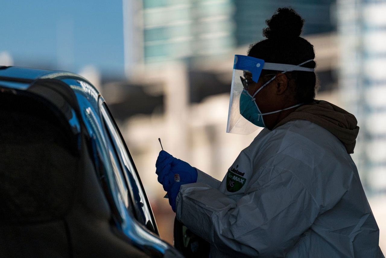 A health care worker in San Francisco administers a nasal swab test at a Covid-19 testing site on December 1.