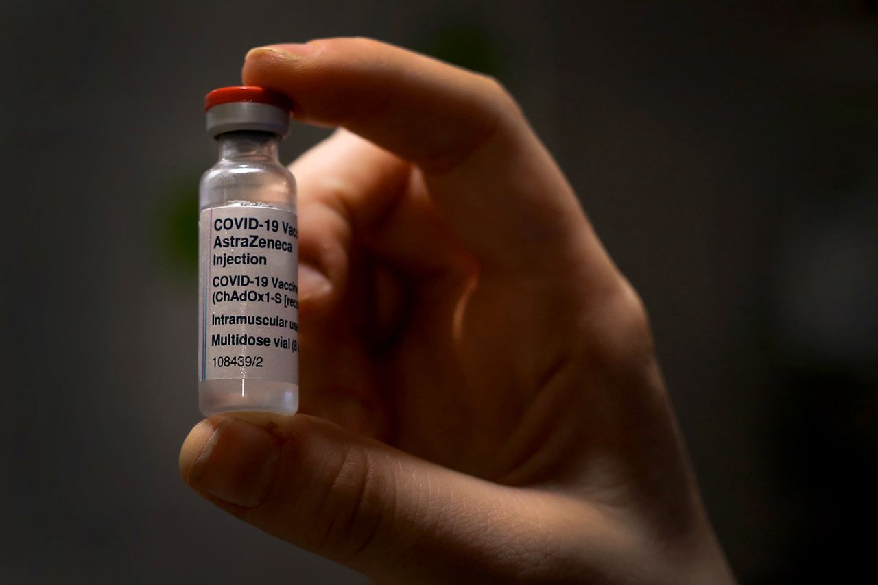 A nurse handles an AstraZeneca COVID-19 vaccine vial in Sydney, on March 23.