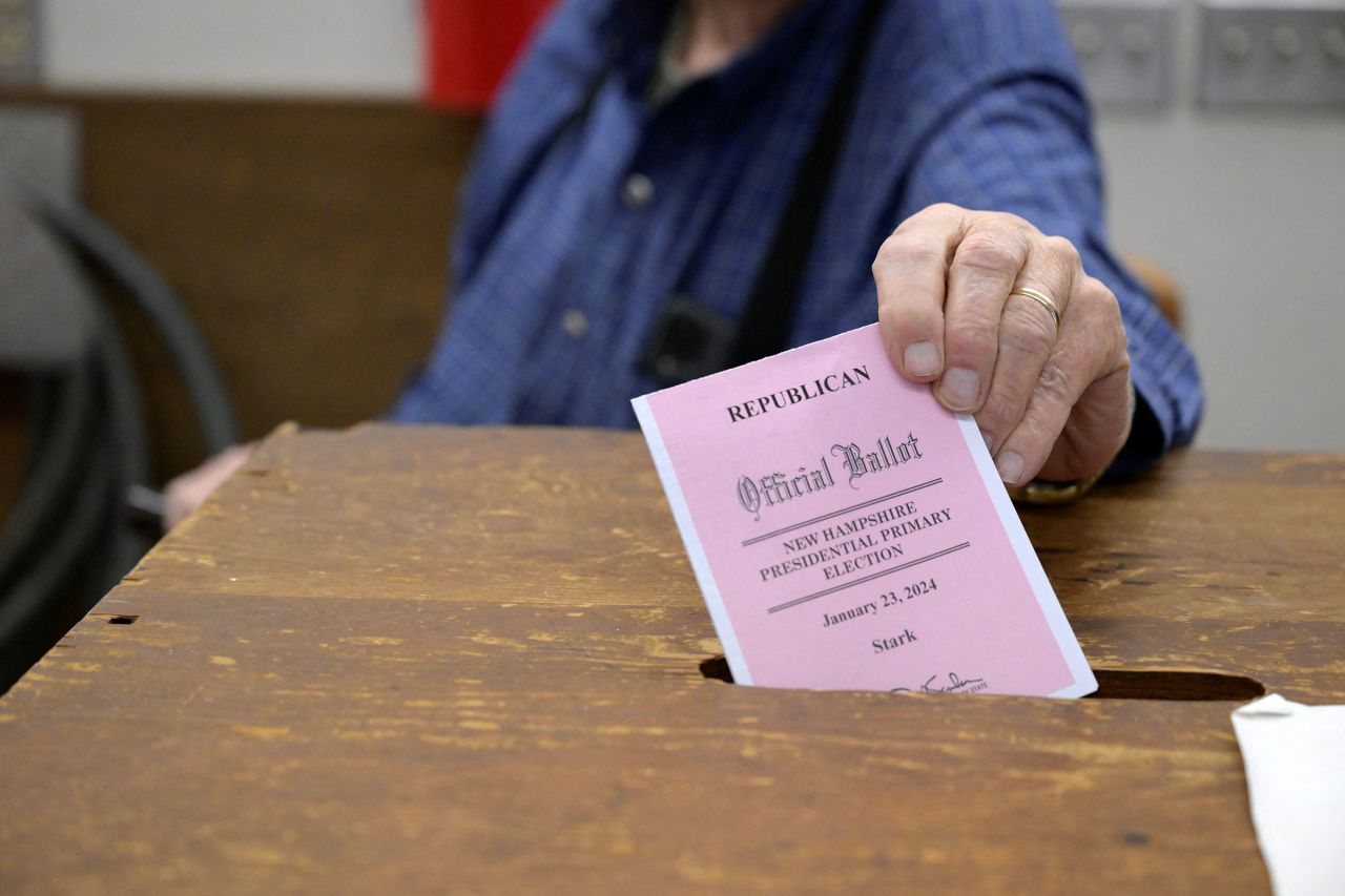 Bill Joyce, Stark moderator enters a ballot into the voting box during New Hampshire's first-in-the-nation presidential primary election at the Stark Volunteer Fire Department in Stark, New Hampshire, on Tuesday.