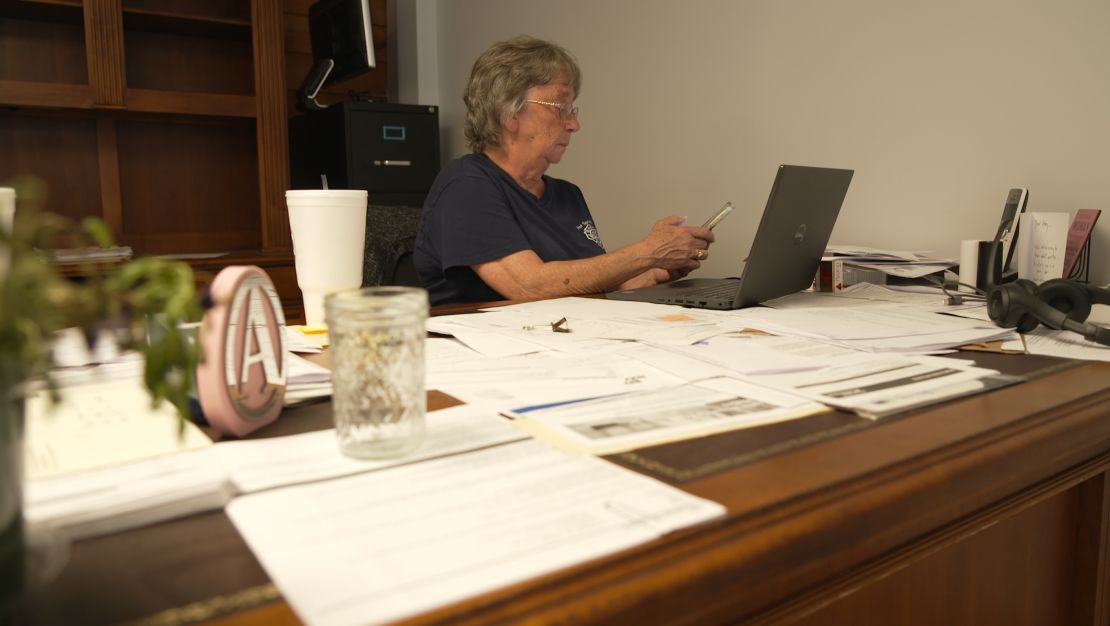 Hot Springs Mayor Abby Norton works at her temporary office. The building that was home to the mayor, sheriff and other town officials was heavily damaged in the floods.