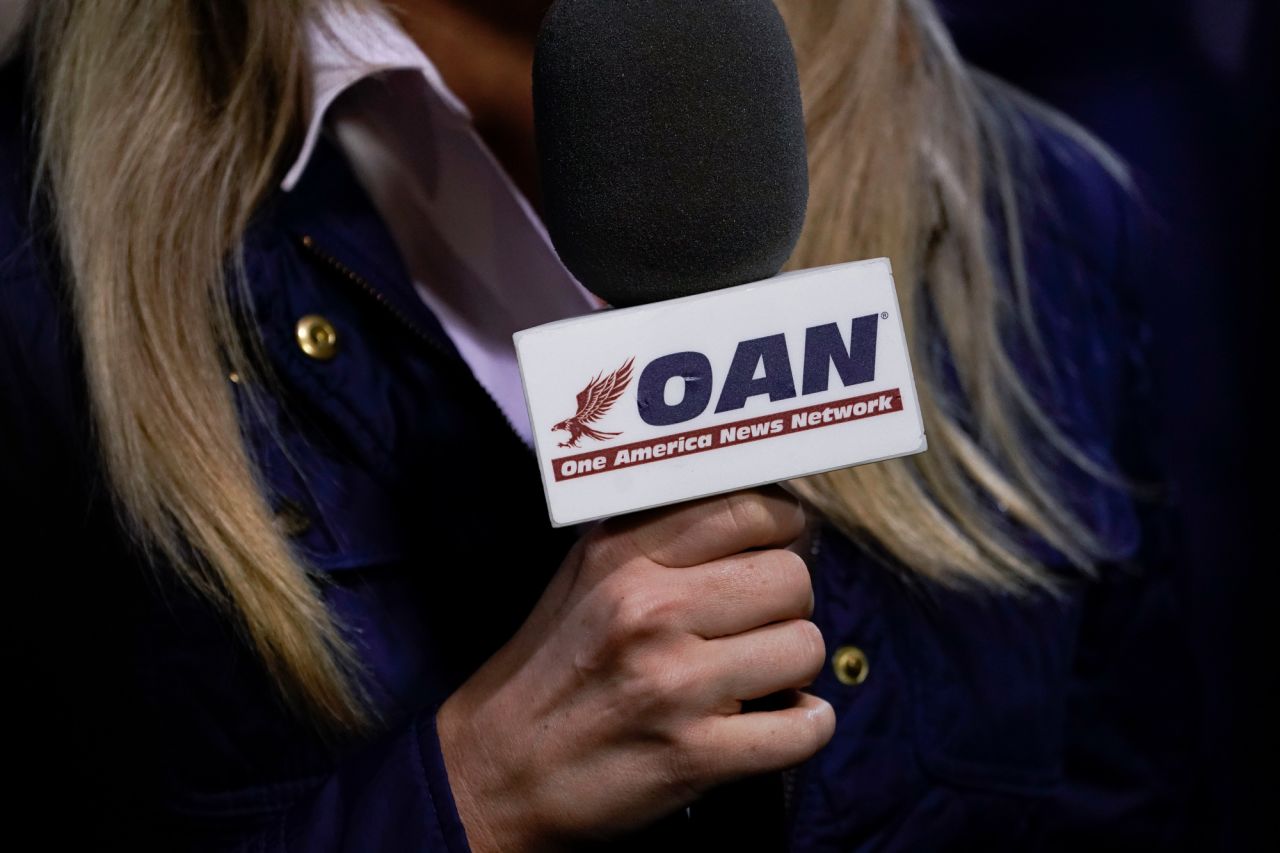 A reporter with One America News Network works at a campaign rally at Newport News/Williamsburg International Airport on September 25 in Newport News, Virginia. 