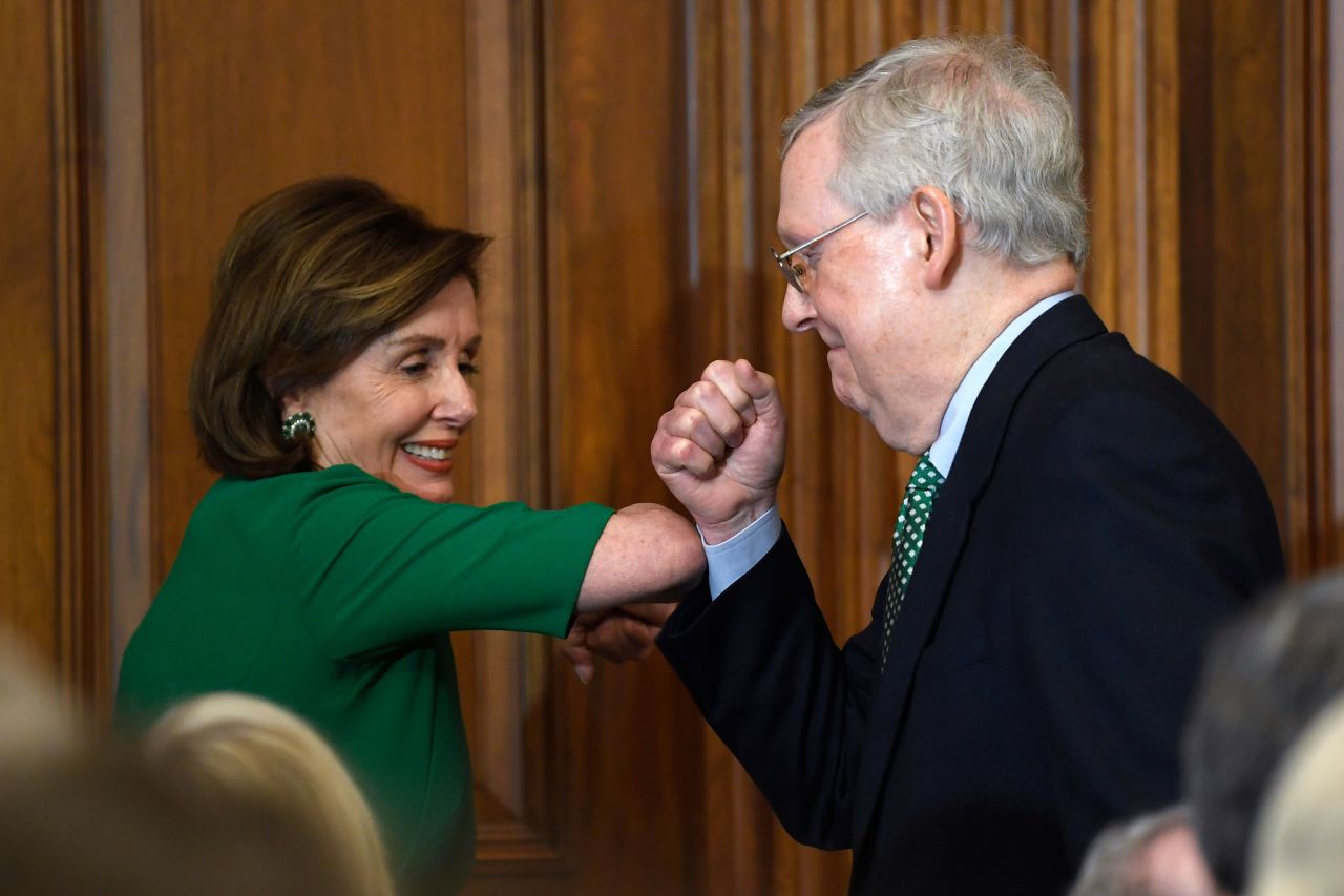 House Speaker Nancy Pelosi and Sen. Majority Leader Mitch McConnell bump elbows as they attend a lunch with Irish Prime Minister Leo Varadkar on Capitol Hill on March 12.