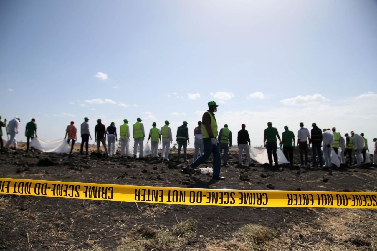 Forensics investigators and recovery teams work at the crash site near Bishoftu.