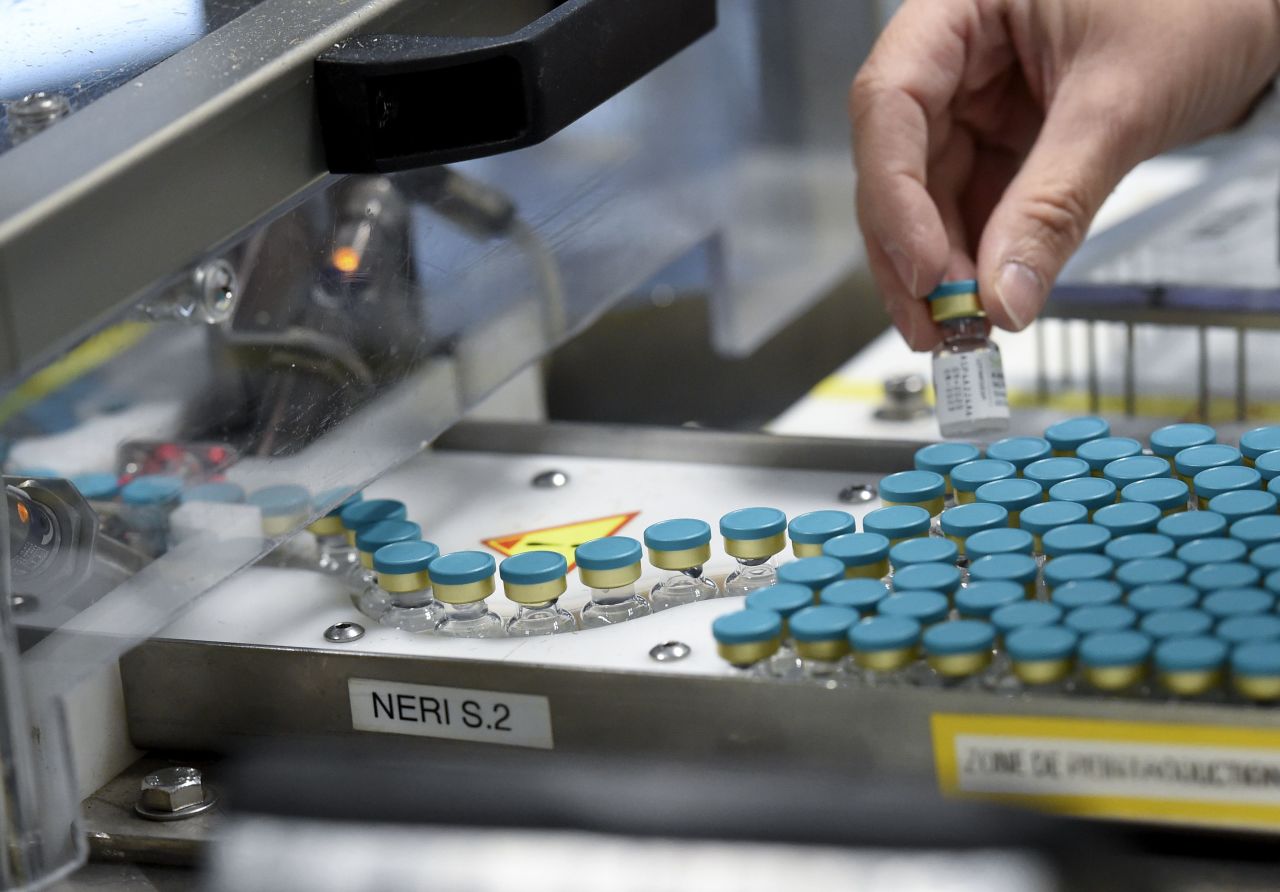 An employee works on a production line at a GlaxoSmithKline factory in northern France, where adjuvant -- or the immune system booster -- for Covid-19 vaccines is manufactured.