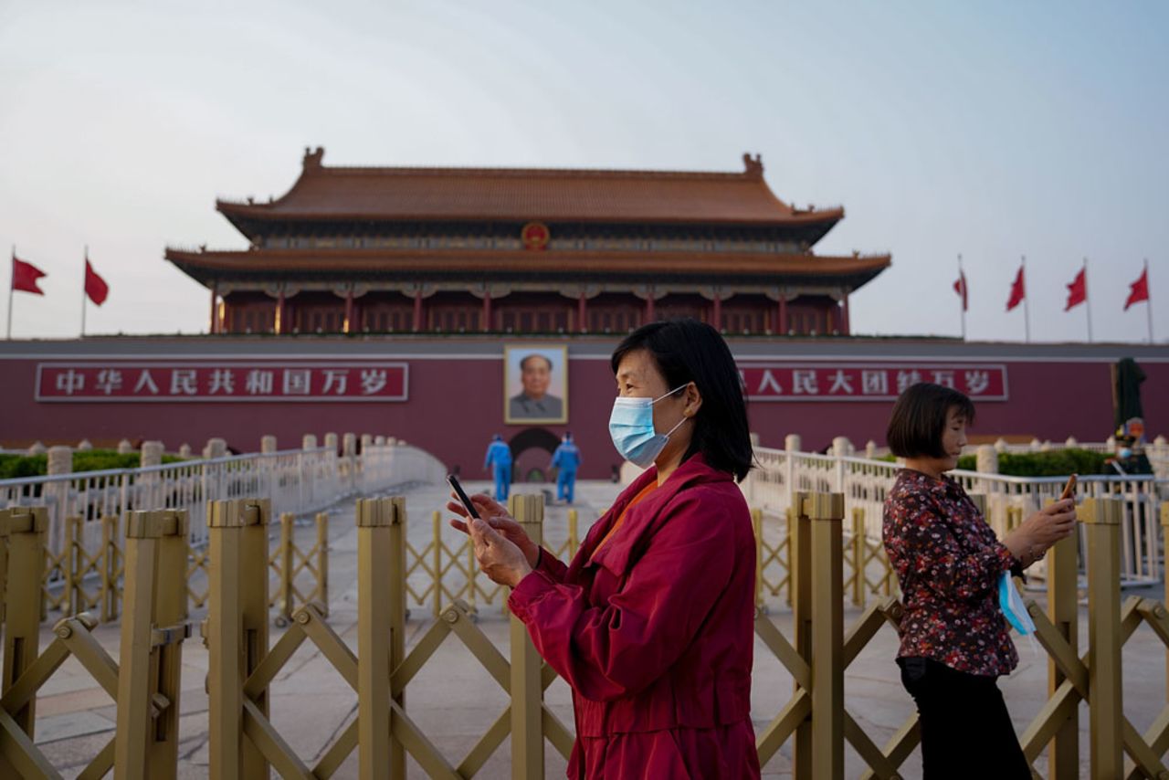 Two women wear protective masks as they visit Tiananmen gate on April 29 in Beijing. 