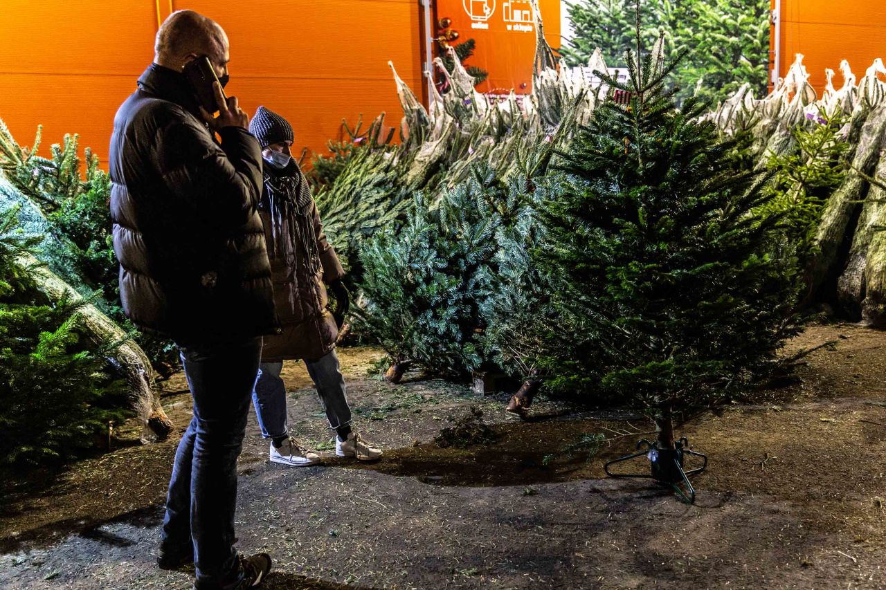 A couple is seen choosing a Christmas tree in Bronowice shopping mall in Krakow, Poland, as the city prepares for Christmas amid coronavirus restriction measures, on December 16.