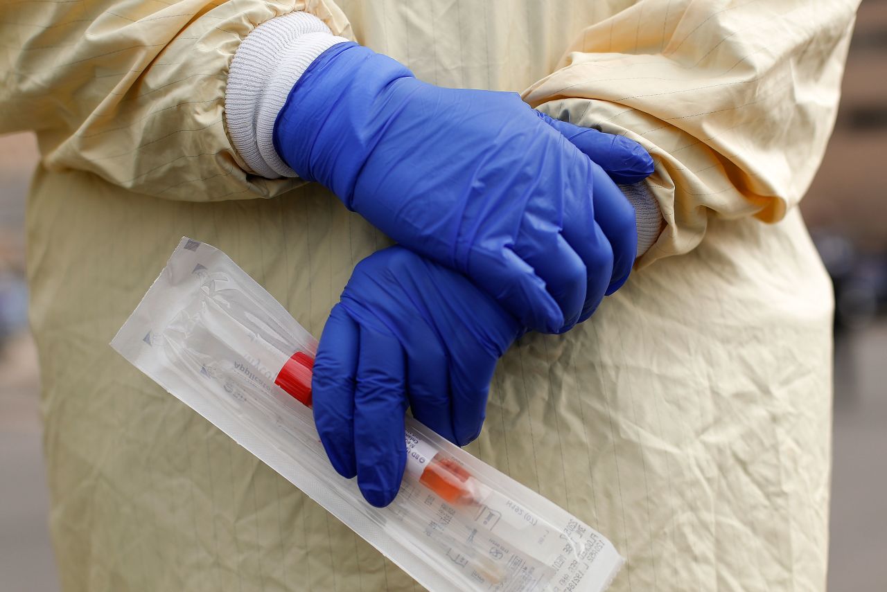 A nurse holds a swabs and test tube kit to test people for coronavirus at a drive through station set up at Beaumont Hospital in Royal Oak, Michigan on March 16.