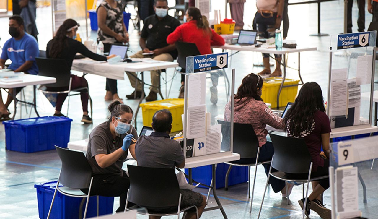 People get vaccinated at a vaccination clinic at Save Max Sports Center in Brampton, Ontario, Canada, on July 10.