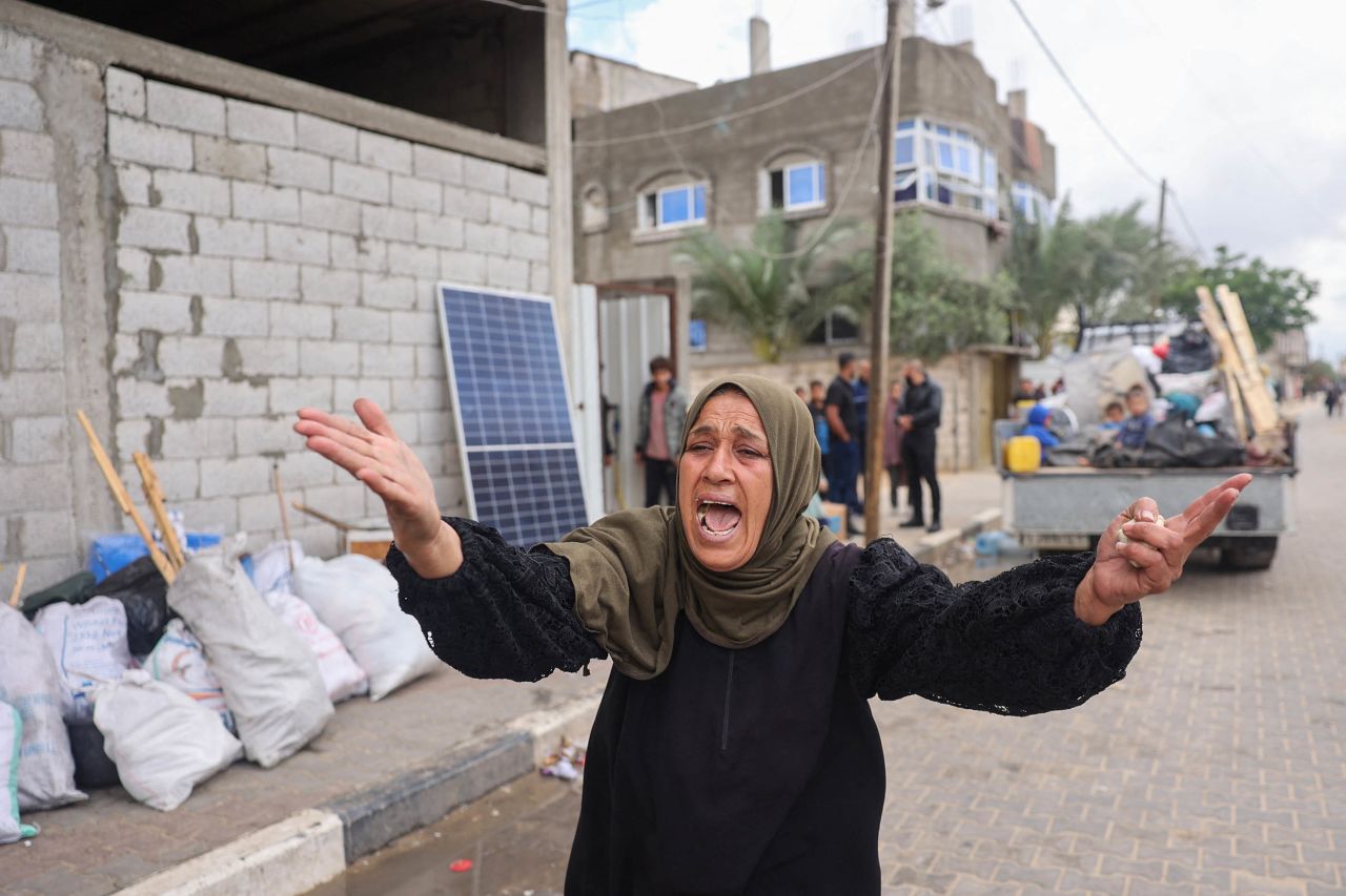 A woman reacts as displaced Palestinians pack their belongings in Rafah, following an evacuation order by the Israeli army on May 6. 