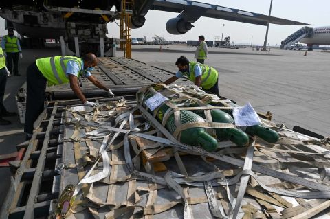 Ground staff unload Covid-19 relief supplies sent from the US, at Indira Gandhi International Airport in New Delhi, on April 30. 