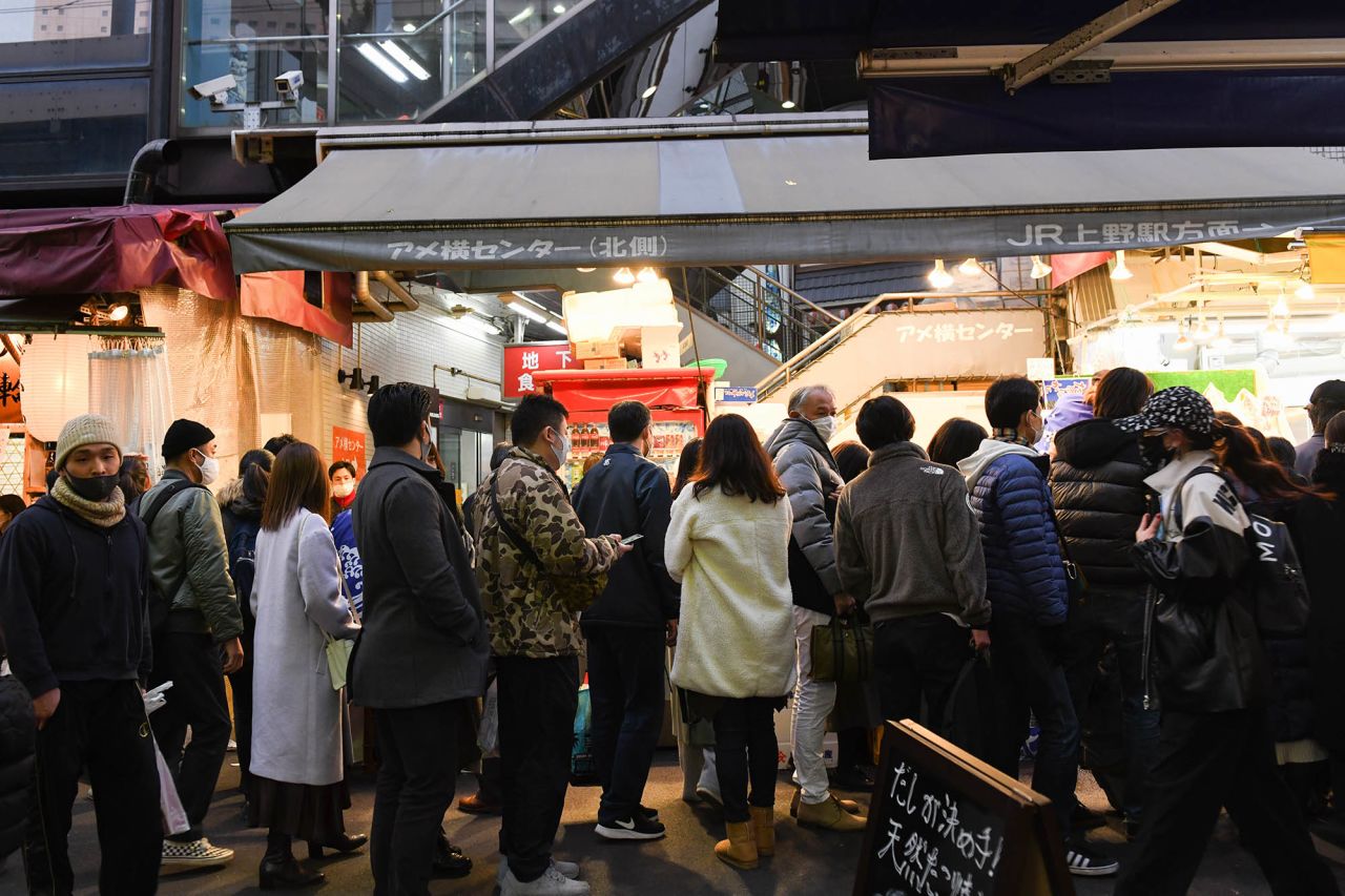 Shoppers stand outside stores at the Ameya Yokocho market in Tokyo, Japan, on Wednesday, December 30.