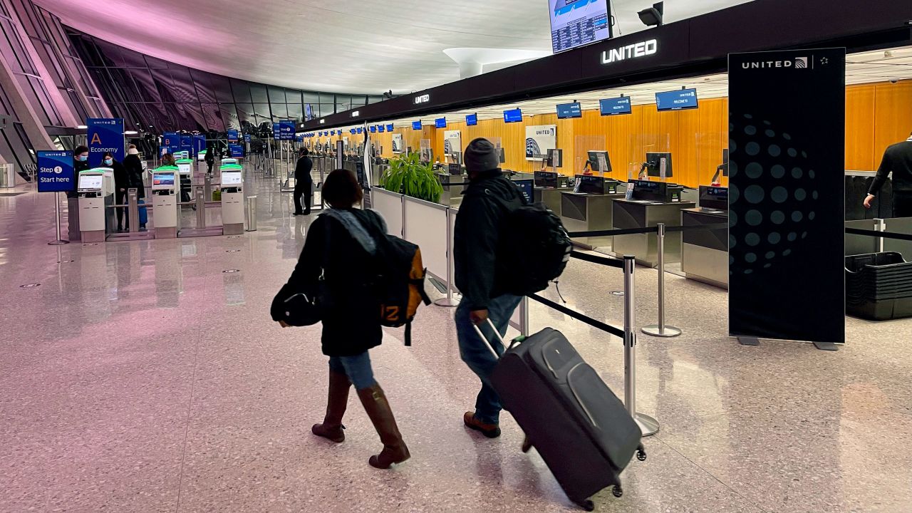 Travelers walk through Dulles International Airport in Dulles, Virginia, on March 2. 