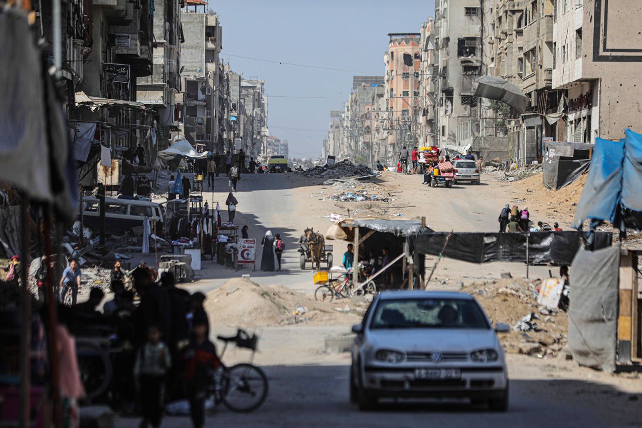 Palestinians leave the Jabalya Refugee Camp with their belongings in Gaza, on May 12.