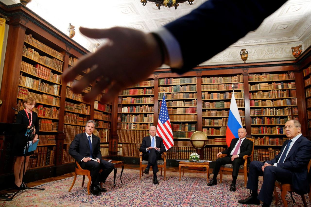 A security officer asks the media to step back at the start of?a summit between Biden and Russian President Vladimir Putin?in June 2021. Seated from left are US Secretary of State Antony Blinken, Biden, Putin and Russian Foreign Minister Sergey Lavrov. The summit, held in Geneva, Switzerland, was the first meeting of Biden and Putin since Biden was elected President.?