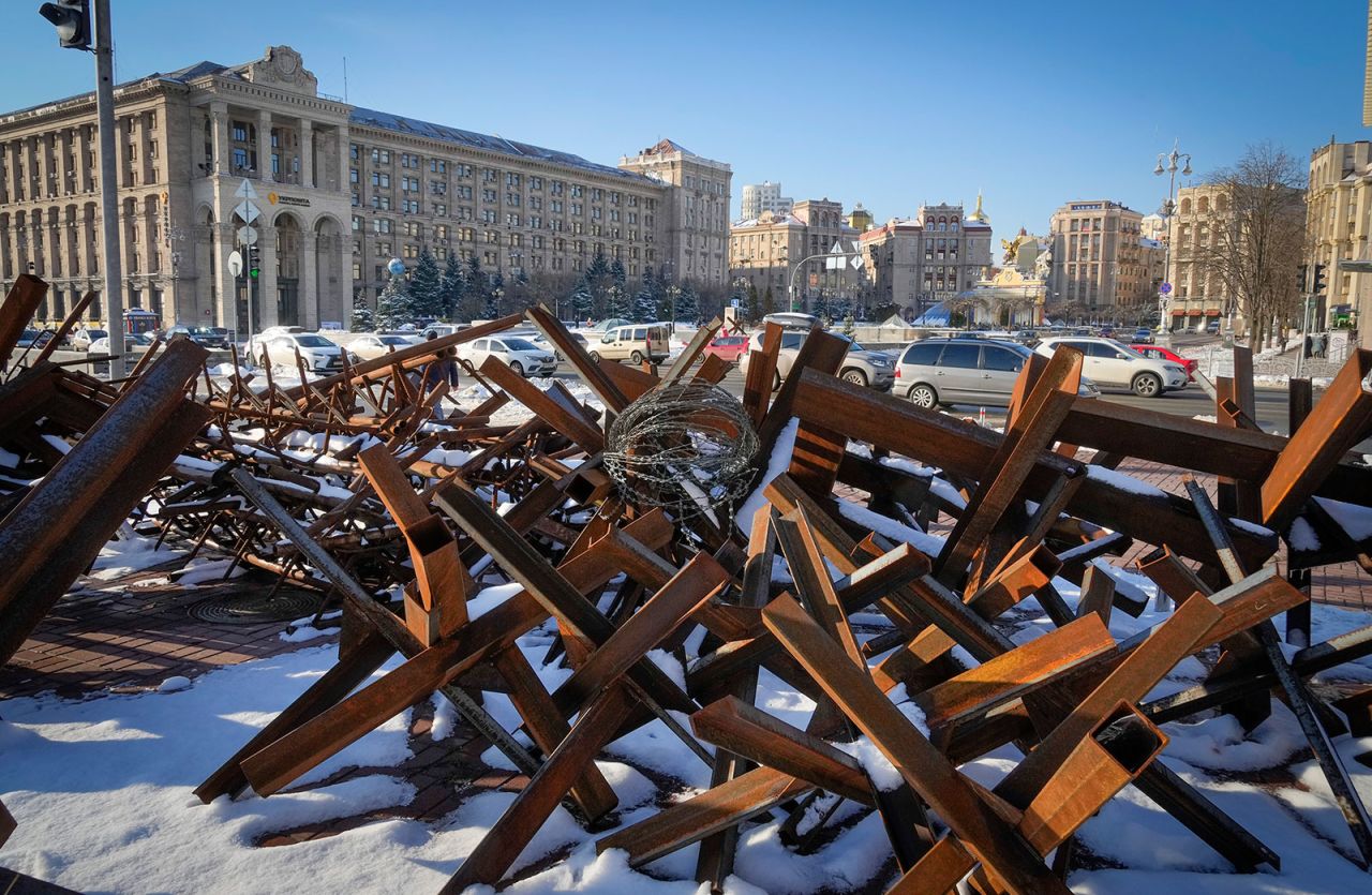 Cars ride past anti-tanks equipment in Kyiv on December 1.