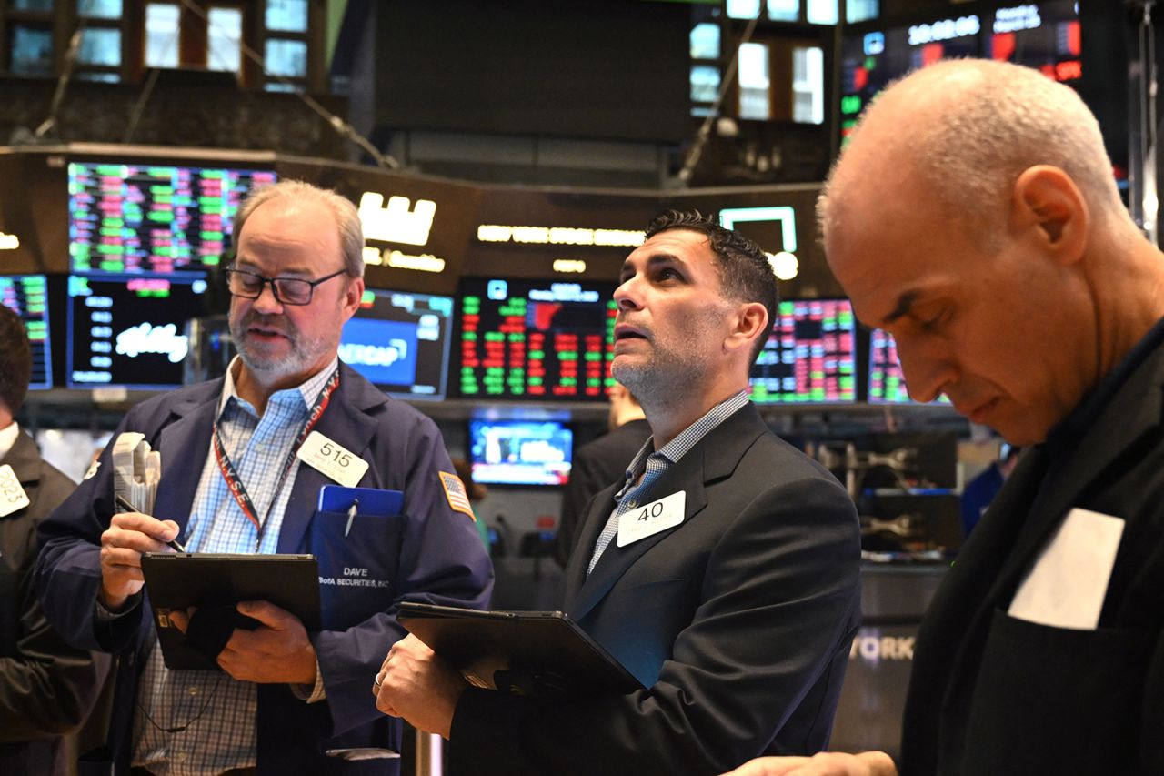 Traders work on the floor of the New York Stock Exchange today during morning trading.