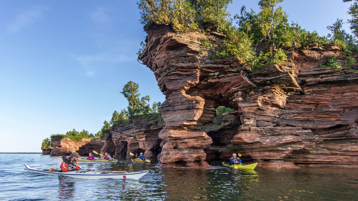 Kayakers explore Devils Island sea caves within Apostle Islands National Lakeshore in Wisconsin.