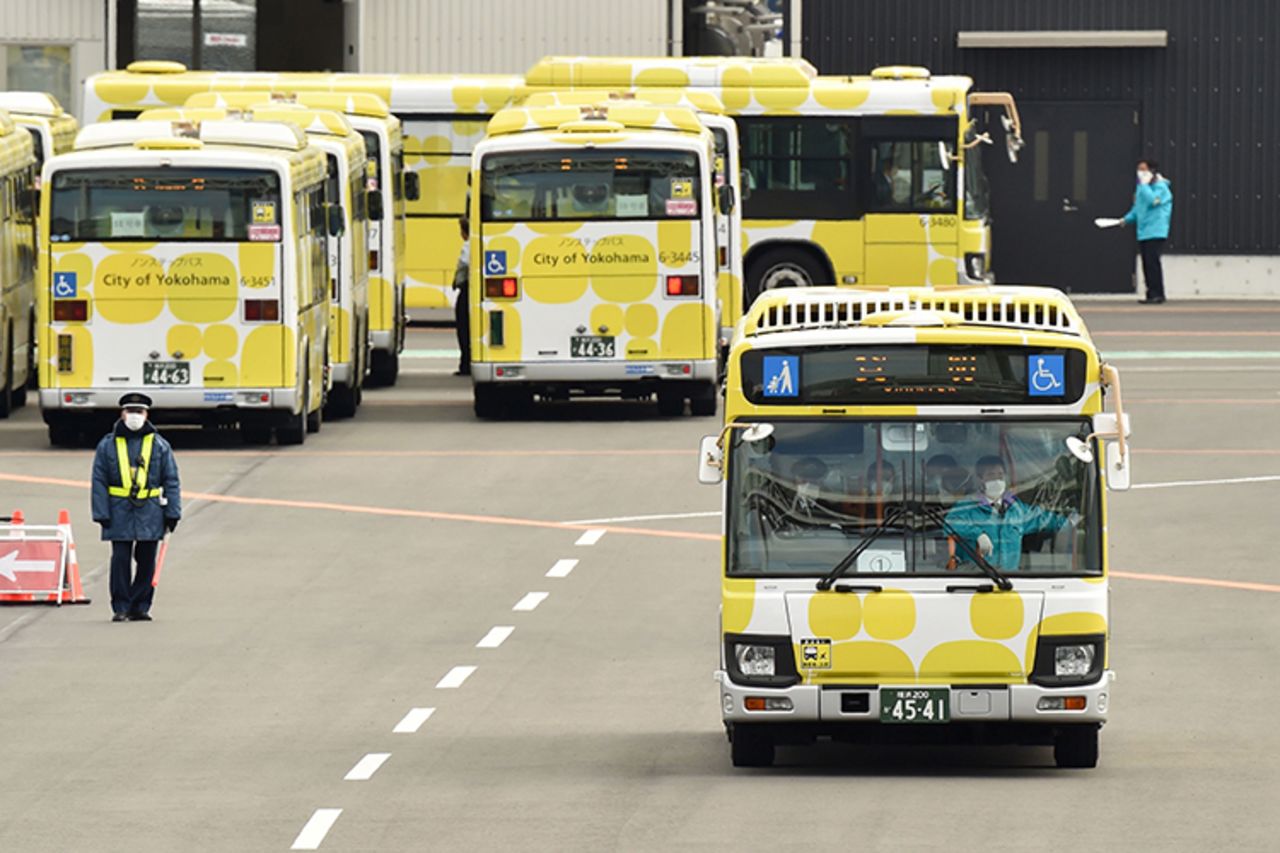 A bus carrying passengers who disembarked from the Diamond Princess cruise ship in quarantine leaves the Daikoku Pier Cruise Terminal in Yokohama on Wednesday, February 19.