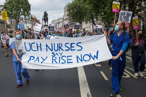 Healthcare workers and supporters take part in a protest march from University College Hospital to Whitehall on July 3, in London. 
