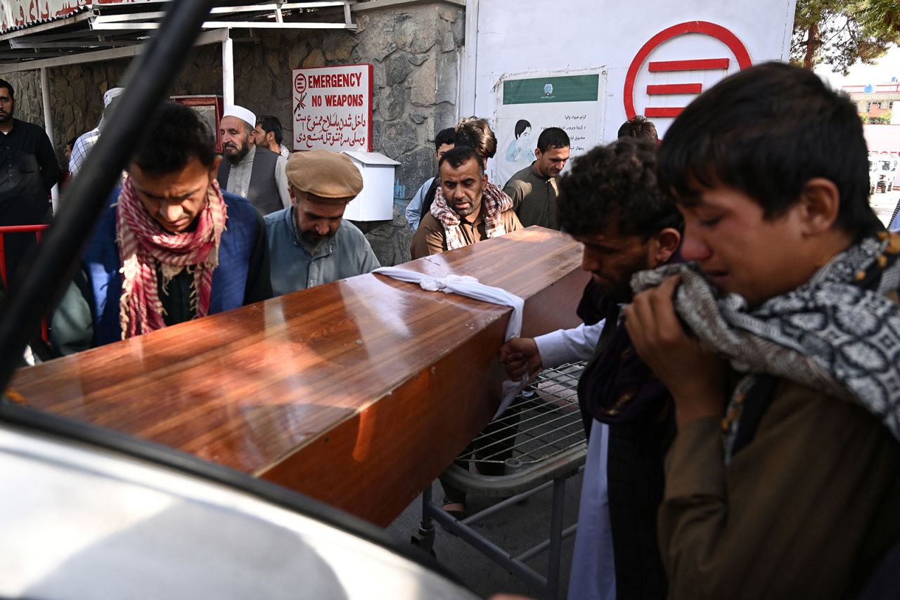 Relatives load in a car the coffin of a victim of the explosion at the Abbey gate?at Hamid Karzai International airport on Friday, August 27, in Kabul.