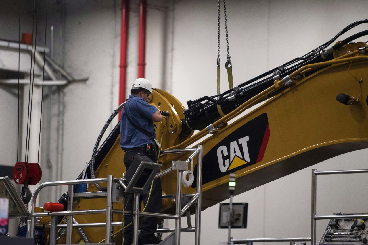 An employee assembles an excavator stick at the Caterpillar Inc. manufacturing facility in Victoria, Texas, in August 2018.