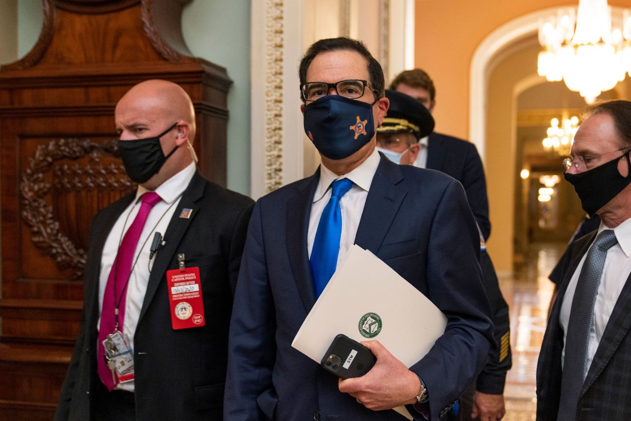 Treasury Secretary Steven Mnuchin, center, leaves the Capitol in Washington, DC, after meetings on September 30.